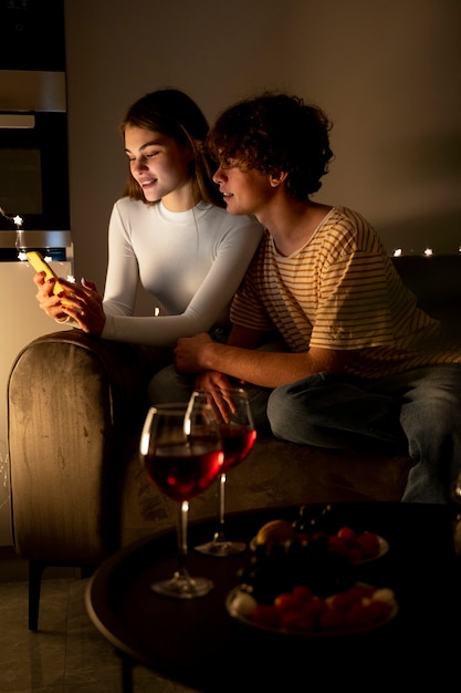 Couple at home using smartphone together