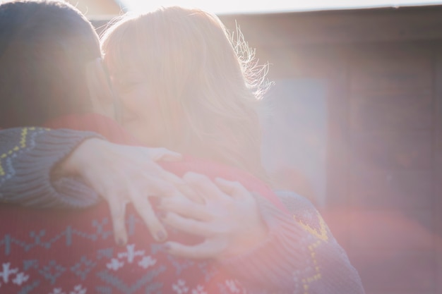 Couple hugging and kissing outdoors