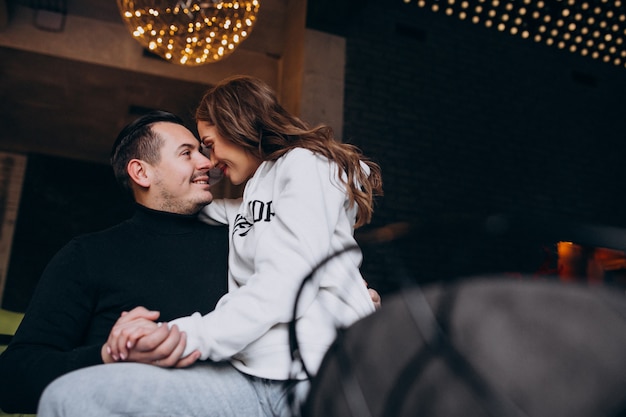 Couple hugging and sitting together inside a cafe