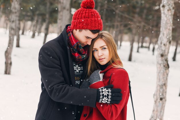 Couple hugging on a snowy field