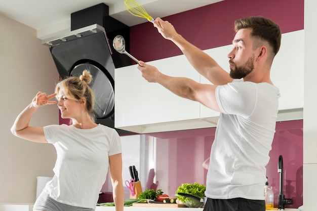 Free photo couple indoors trying to cook