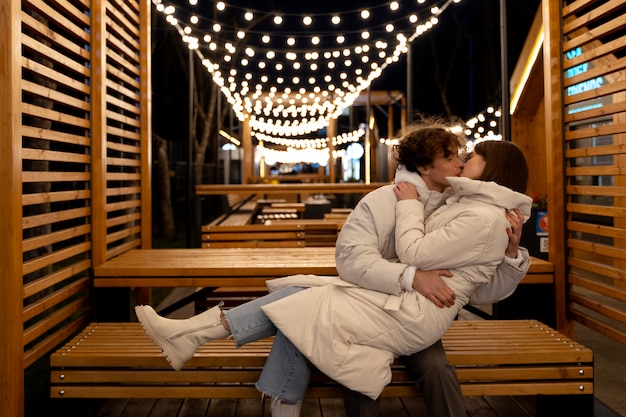 Free photo couple kissing outdoors while embracing