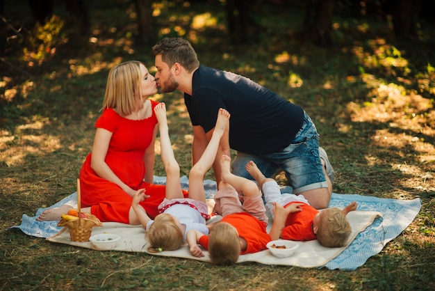 Free Photo couple kissing and playing with children