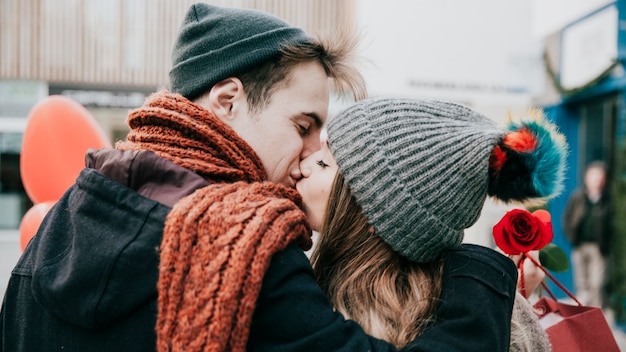 Free photo couple kissing on street