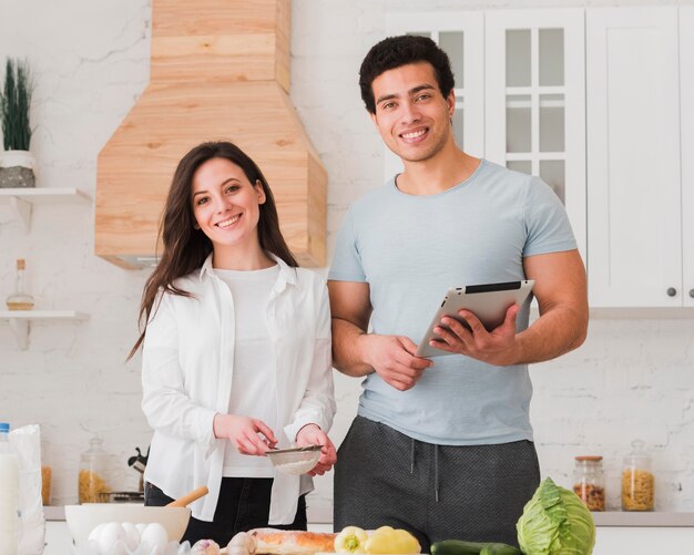 Couple learning recipes from online courses