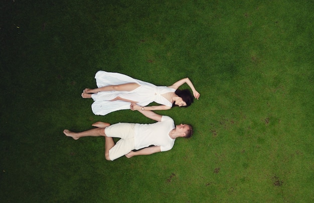 Free photo couple lie on a graas on a bali