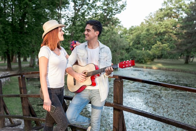 Couple looking at each other at a bridge 