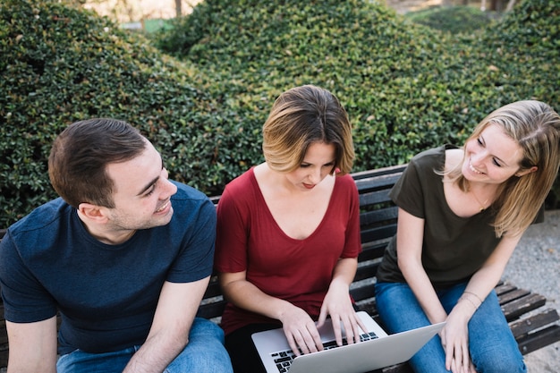 Free photo couple looking at each other near woman with laptop