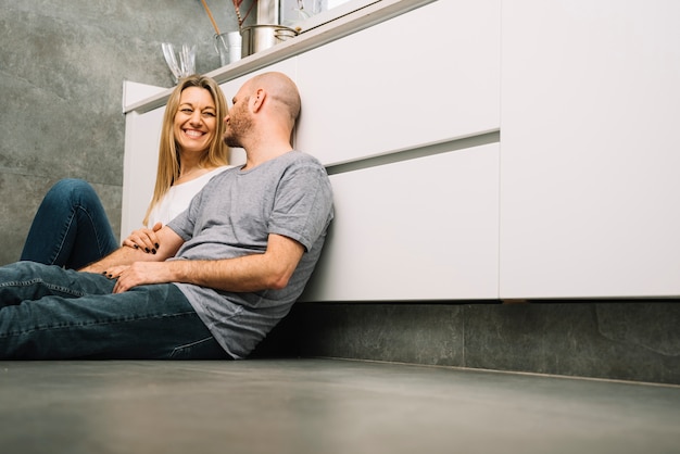 Free photo couple in love on floor in kitchen