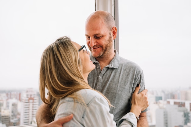 Free photo couple in love in front of window