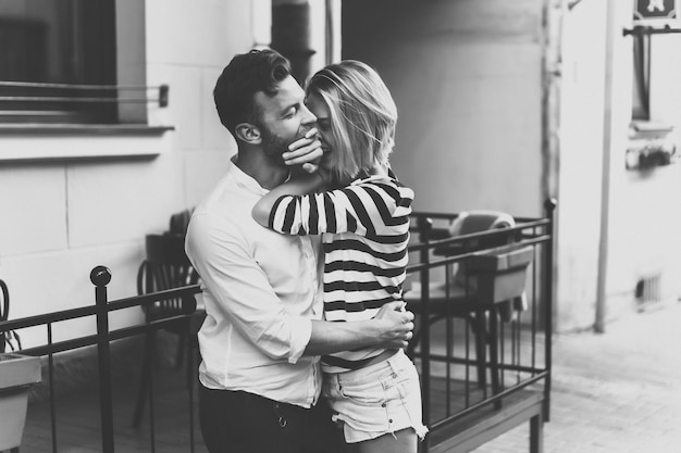 Free photo couple in love hugging on the street