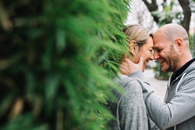 Couple in love behind tree