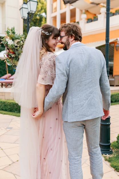 Couple  in love walking in luxury villa while celebrating  wedding .