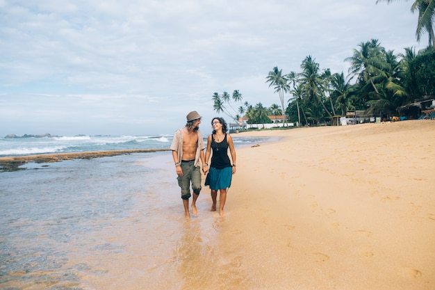 Free Photo couple in love walking together on the seashore