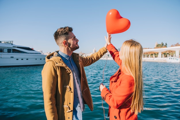 Couple in love with red balloon