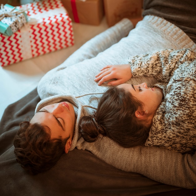 Free photo couple lying at present boxes