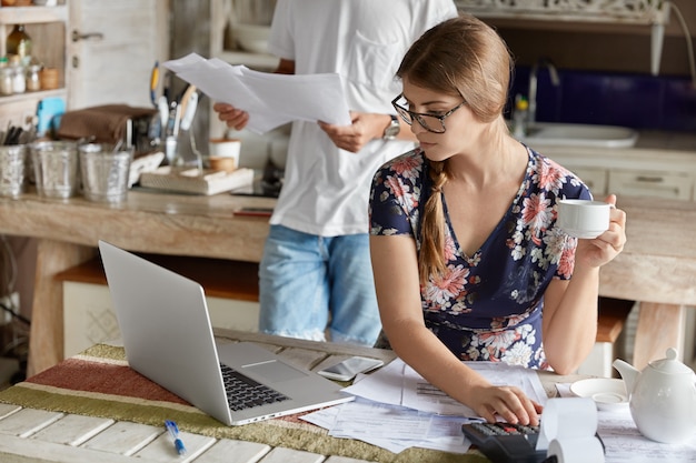 Couple managing budget together in kitchen