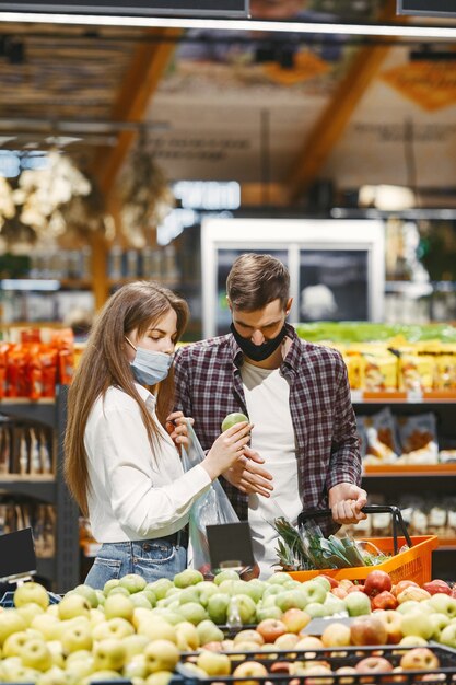 Couple in medical protective mask in a supermarket.