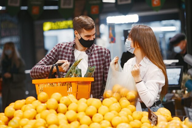 Couple in medical protective mask in a supermarket.