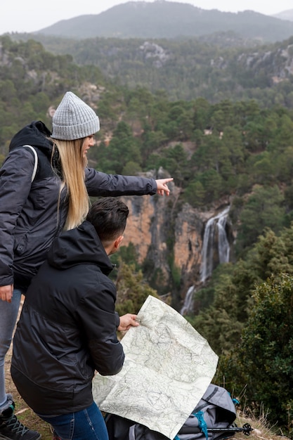 Free Photo couple in nature consulting map