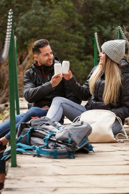 Couple in nature drinking water