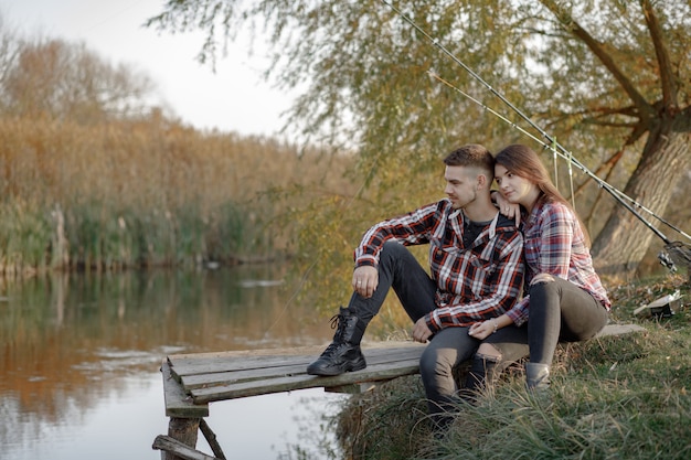 Couple near river in a fishing morning