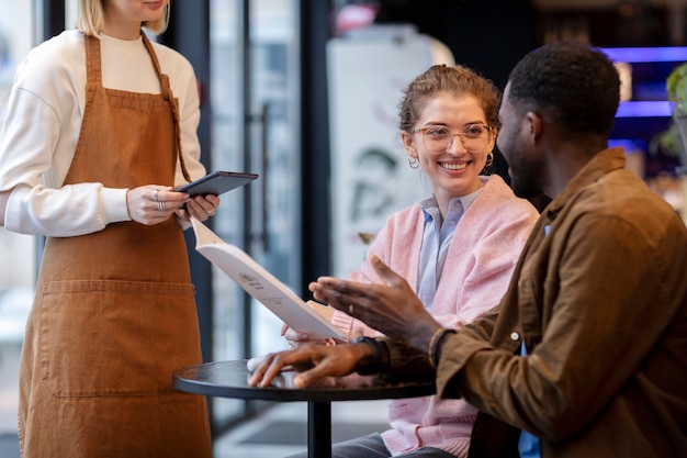 Free photo couple ordering food at restaurant