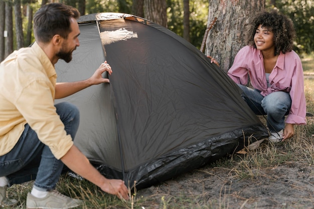 Couple outdoors setting tent