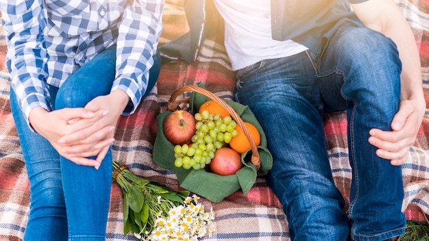 Couple at picnic on lawn in park