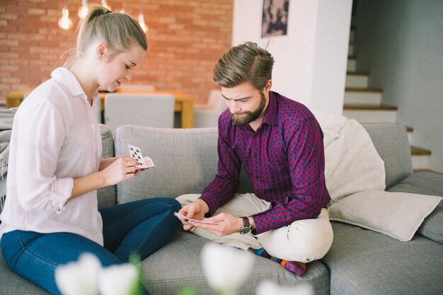 Couple playing cards on couch