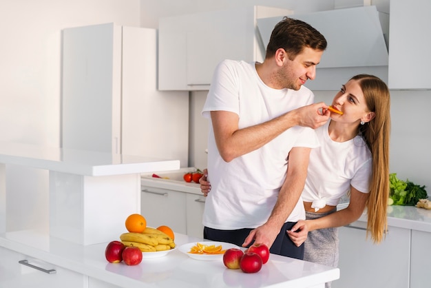 Free Photo couple playing while cooking