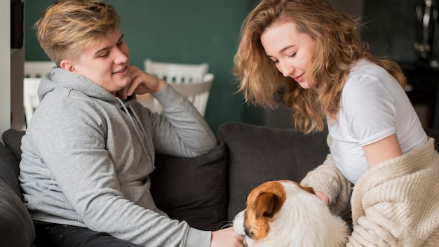 Free Photo couple playing with dog at home