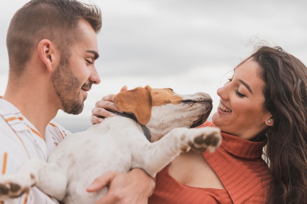 Free photo couple playing with dog