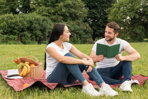 Couple posing on a picnic blanket