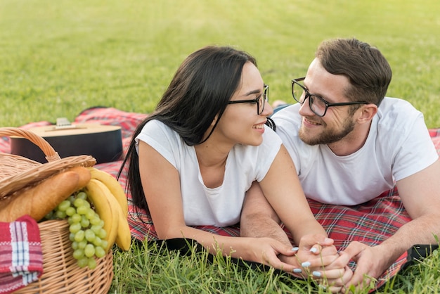 Couple posing on a picnic blanket