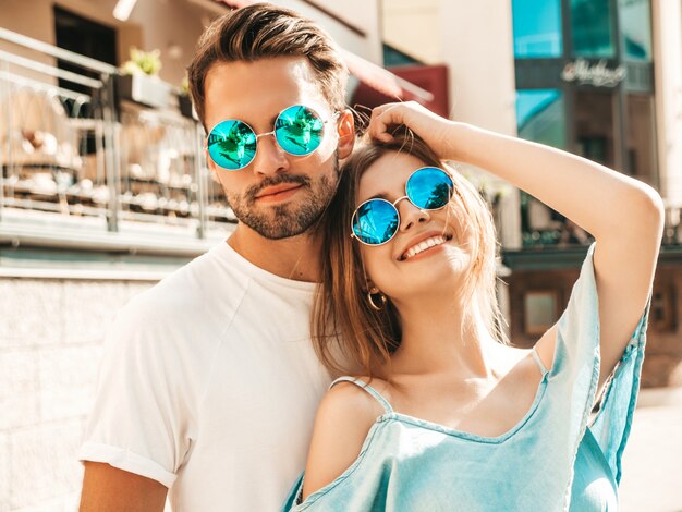 Couple posing on the street in sunglasses