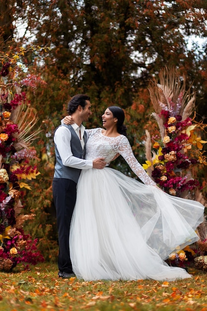 Free photo couple posing at wedding full shot