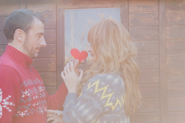 Free Photo couple posing with paper heart