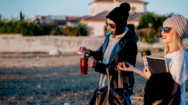 Free Photo couple pouring sugar into thermoses