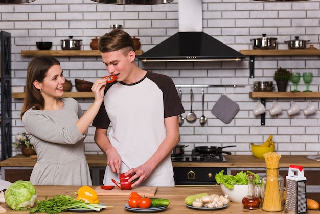 Free Photo couple preparing fresh vegetables together at home