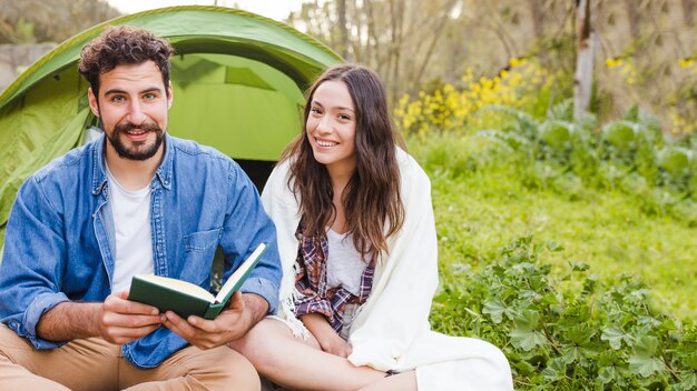 Couple reading near tent