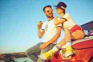 Free photo couple resting on the beach on a summer day near river. love, happy family, vacation