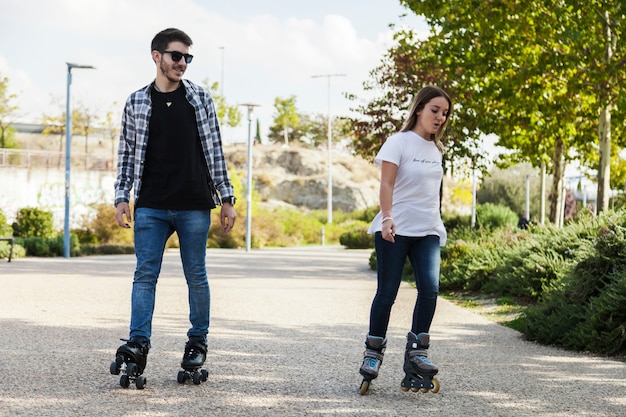 Couple roller skating in park