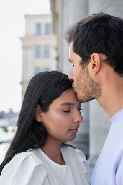 Free photo couple sharing tender public intimacy moments