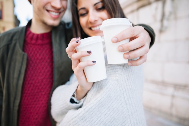 Free photo couple showing plastic cups