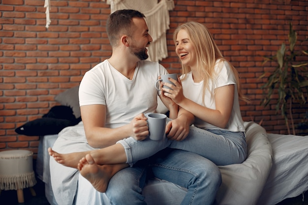 Couple sitting on a bed in a room