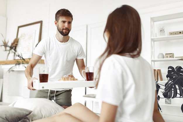 Couple sitting on a bed in a room