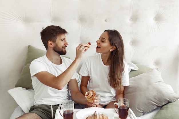 Couple sitting on a bed in a room