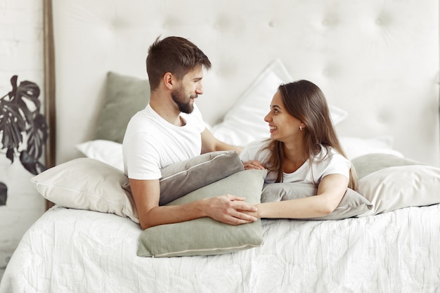 Couple sitting on a bed in a room