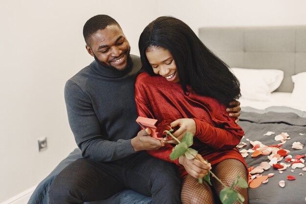 Couple sitting on a bed on Valentine's Day